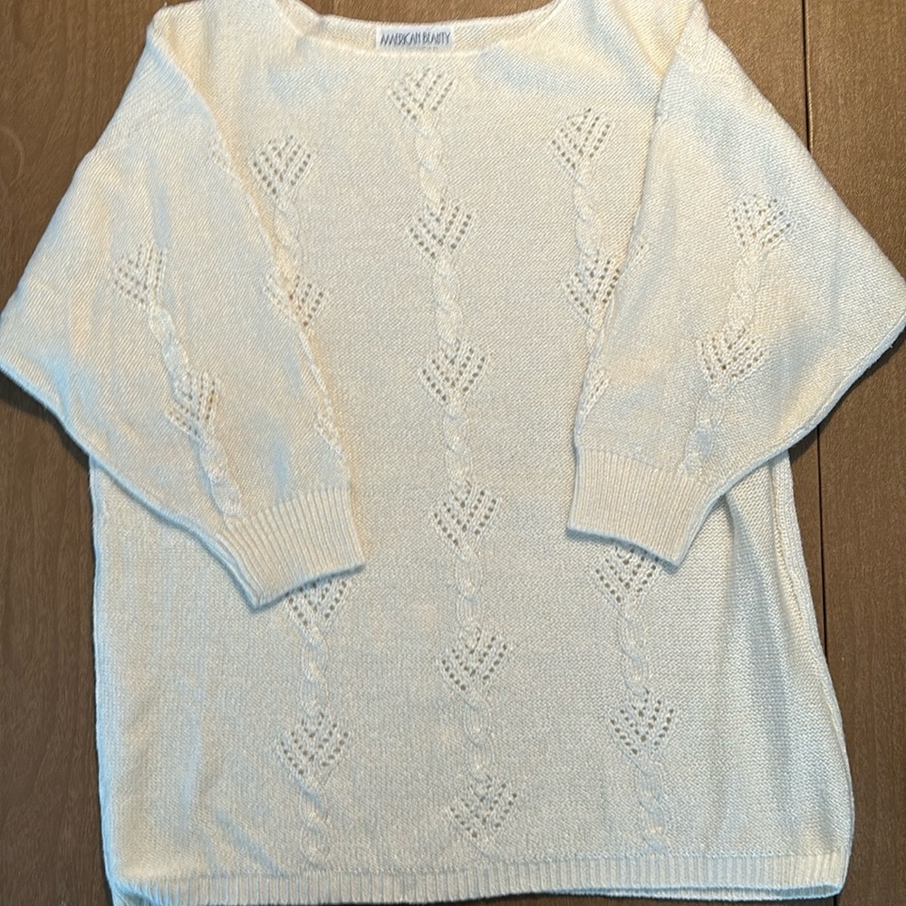 Off. White sweater with quarter length sleeves.